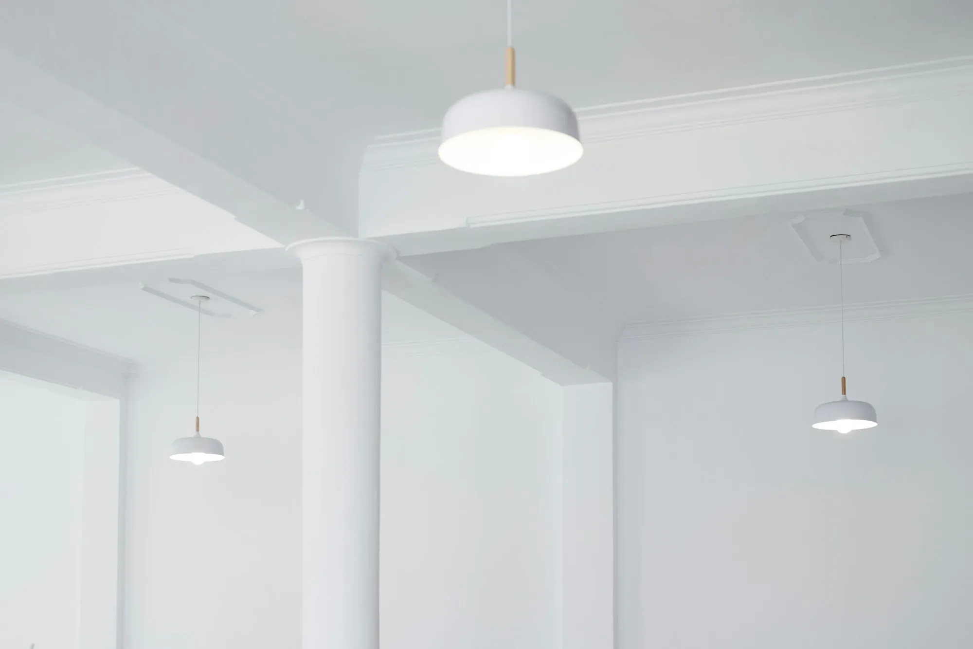 Modern kitchen with pendant lights over a white island