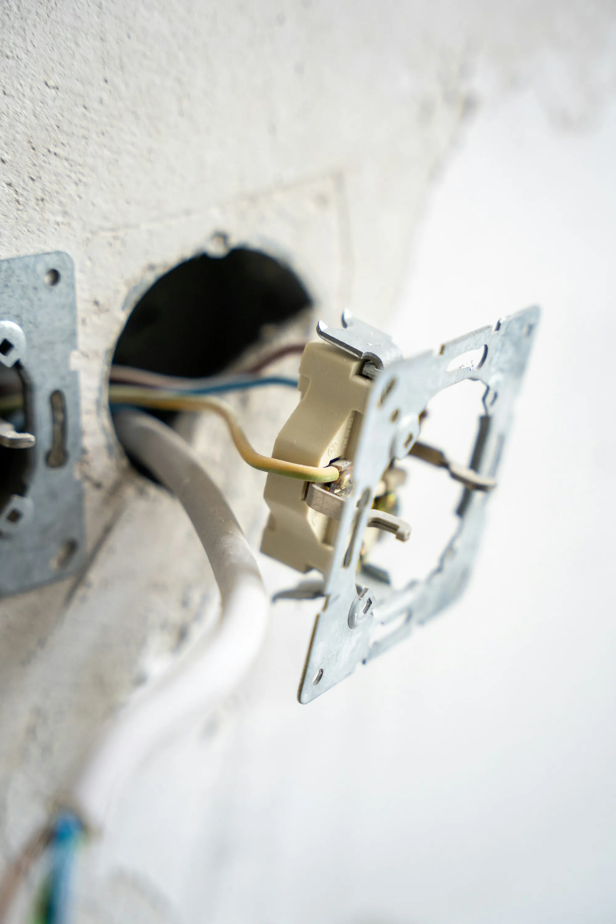 Electrician fitting a wall plate over a new switch